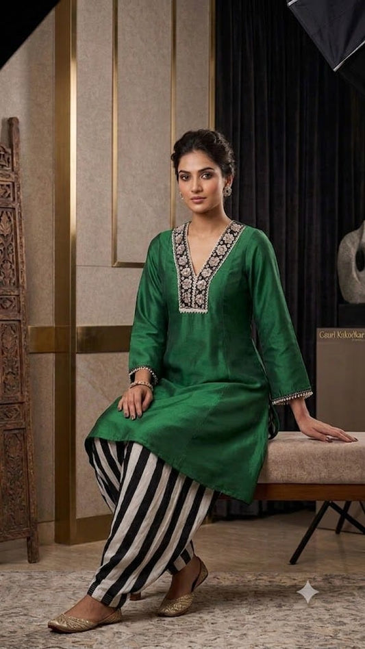 Bottle green dupion silk a-line kurti with black and cream crape salwar.